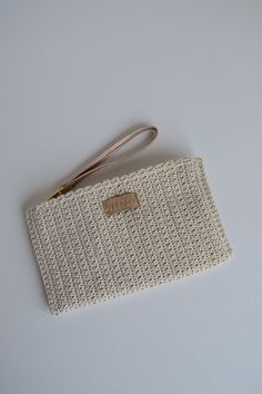 Knitted mini clutch Fully lined With wrist handle Cream and powder colors are available Cream Woven Clutch For Everyday Use, Woven Cream Clutch For Everyday, Casual Handmade Beige Clutch, Handmade Casual Beige Clutch, Cream Crochet Clutch Bag For Everyday Use, Handmade Beige Rectangular Pouch, Beige Crochet Rectangular Clutch, Everyday Beige Crochet Clutch Bag, Beige Crochet Clutch Bag For Gift