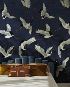 there are many birds flying over the bed