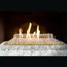 a fire is burning in a fireplace with ice on the floor