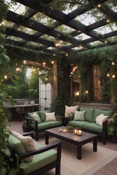 an outdoor living area with couches, tables and lights