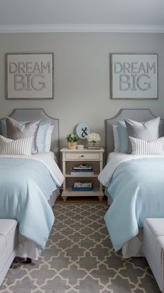 two beds in a bedroom with blue and white bedding