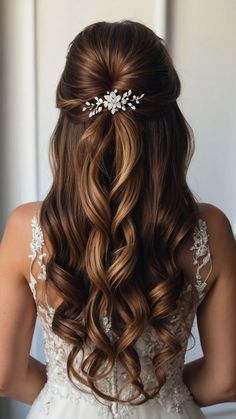 the back of a woman's head with long hair and a flower in her hair