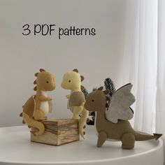 three stuffed animals sitting on top of a white table next to a window with the words 3 df patterns above them