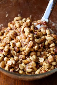 a bowl filled with nuts on top of a wooden table