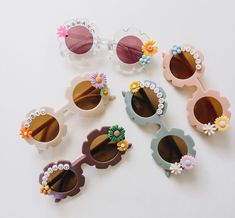 "These personalizable sunglasses are the perfect for your littles this spring and summer! There are many colors to choose from, and the customization possibilities are endless! Add your child's name, or a cute phrase like \"flower power\", \"flower child\", \"mini\", etc. These make a great gift for baby showers or birthday parties! They fit babies and children of all ages up to about 10 years old. * Choose the color of sunglasses * Add your customization in the personalization box (max of 10 ch Groovy Sunglasses, Beads Sunglasses, Baby Glasses, Flower Props, Girl Sunglasses, Boy Party Favors, Baby Sunglasses, Flower Sunglasses, Cute Phrases