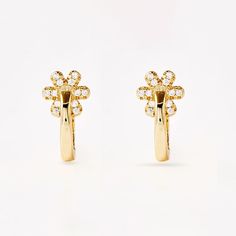 Introducing our stunning Grow Untamed Earrings, the perfect accessory for those looking for a touch of wild elegance. Crafted from 925 sterling silver with a 14k gold plating, the huggie style features a subtle flower detail. Whether worn on their own or paired with other pieces, these earrings are sure to make a statement. Maintain your jewellery’s high shine by avoiding contact with any chemicals such as soap, perfume, lotion, makeup, hair & cleaning products. Luxury Sterling Silver Flower Earrings, Luxury Flower Diamond Earrings, Luxury Flower-shaped Diamond Earrings, Fine Jewelry Yellow Gold Flower Earrings, Elegant Flower Shaped Diamond Earrings, Classic Gold Flower Earrings In Sterling Silver, Classic Gold Sterling Silver Flower Earrings, Elegant 14k Yellow Gold Flower Earrings, Gold Plated Yellow Gold Flower Earrings