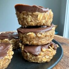 three chocolate covered cookies stacked on top of each other with peanut butter in the middle