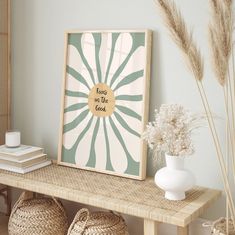 a shelf with baskets and vases on top of it next to a framed art piece