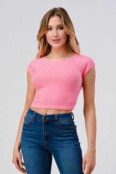 a woman wearing jeans and a pink crop top