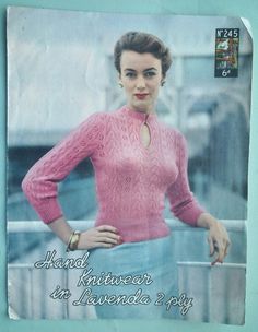 a woman wearing a pink sweater and blue skirt in front of a sign that says hand knitwear in lavender 2 ply