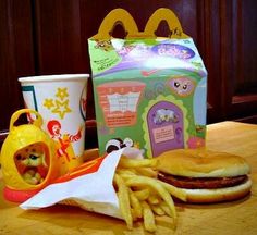 a hamburger and french fries are sitting on a table next to a mcdonald's box