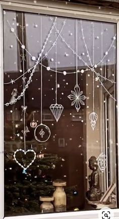 a window decorated with christmas decorations and ornaments