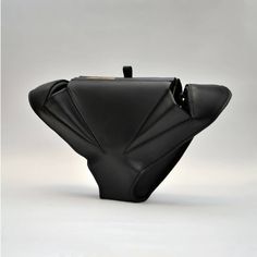 Made from genuine natural Toscan leather without chrome. A unique shape inspired by the animal world and organic lines. It can be held in the hand for a more elegant style or used with a detachable leather strap.The bag has one small inner pocket and one outer pocket with a classic metal lock. Not only a bag, but also a sculpture to be wornThe dimensions of the envelope are 17x 15 x 10 cmFor carrying in the hand or over the shoulder thanks to a removable leather strip with a length of 120 cm.Han