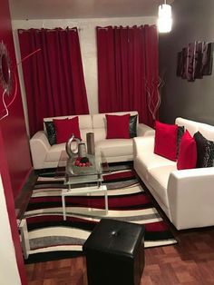 a living room filled with furniture and red curtains