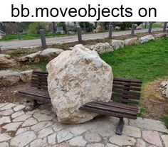 a large rock sitting on top of a wooden bench