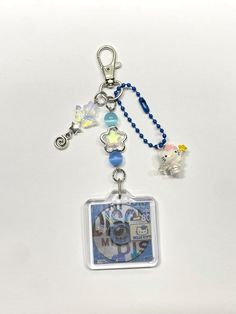 a keychain with an animal charm attached to it's side and beads around the clasp