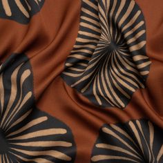 an orange and black fabric with white swirls on it's side, in the background