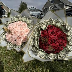 two bouquets of roses sitting on top of each other in the middle of grass