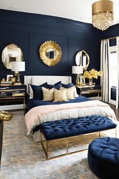 a bedroom with blue walls and gold accents