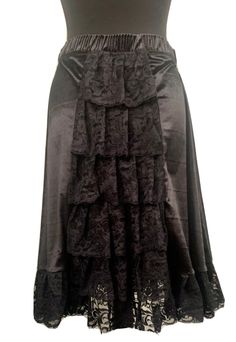 "This is a Victorian style gothic steampunk skirt with an elasticated waistband . This is a black midi length velvet mix skirt .can be worn with a corset . It has black lace trim  to the boarder. It also has ruffles of lace towards the back, tiered please see photos. It's a free size ,waist 25 before stretch . Stretches to approx 38\".please refer to photo for length . This is a midi  Available in 3 colour ways:- Black Red Purple Thank you for looking" Gothic Tiered Skirt For Halloween, Gothic Ruffled Skirt For Costume Party, Black Gothic Velvet Bottoms, Black Velvet Gothic Bottoms, Gothic Long Ruffled Skirt, Gothic Long Ruffled Skirt Bottoms, Gothic Tiered Skirt For Costume, Gothic Tiered Ruffle Skirt, Gothic Skirt With Lace Trim