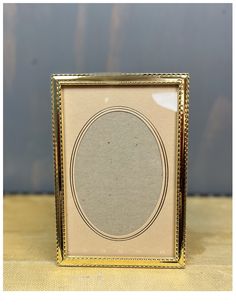 a gold frame sitting on top of a table