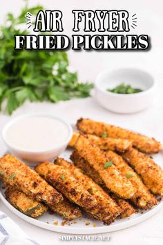 air fryer fried pickles on a white plate with ranch dressing and parsley