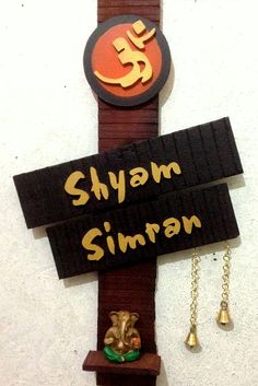 a wooden sign that says shyam simran with an elephant figurine on it