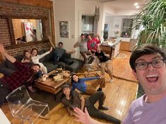 a group of people sitting in a living room together