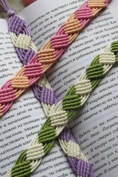 an open book with two braided bracelets on it