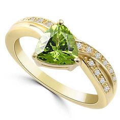 Product Description The 1.29ct trillion-cut peridot is accented with top-quality white diamonds. The ring features a contemporary design and made out of solid 14k gold. Available in white and yellow gold. Product Details Main Stone: Vivid-Green Peridot Clarity: VS clarity (no inclusions) Shape: Trillion-Cut Faceted Weight & Size: 1.29ct, 7mm x 7mm Side Stones: Fine Diamonds (0.16ct) Side Stone Color: VS2-SI1 clarity (Clean) Side Stone Clarity: F color (Colorless) Cocktail Fashion, Diamond Evil Eye, Green Peridot, Stone Engagement, Fashion Ring, Diamond Fashion, Yellow Diamond, White Diamonds, Cocktail Rings