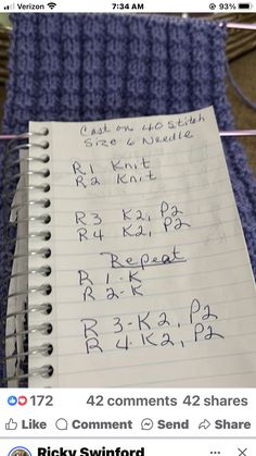 a notepad with writing on it next to some knitting needles