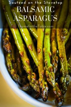 grilled asparagus with balsamic sauce in a white bowl on a table