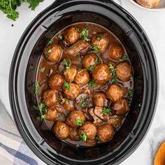 crock pot filled with meatballs and garnished with parsley