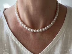 "This classic feminine necklace is made with high quality genuine AAA grade white 8mm freshwater pearls. A delicate, feminine & classy necklace perfect for all occasions. These pearls have high luster, are smooth, perfectly calibrated, and uniform in size. Freshwater pearls symbolize purity, harmony and humility. Pearls are organic gems that are officially the oldest gem coveted by man for their beauty and have been used as a trade commodity for thousands of years. Freshwater pearls were found i Classic Round Bridal Necklace With Pearl Charm, Delicate Round Bead Pearl Necklace For Formal Occasions, Delicate Formal Pearl Necklace With Round Beads, White Akoya Pearl Round Bridal Necklace, White Akoya Pearl Bridal Necklace, White Pearl Necklace With Round Beads For Anniversary, Round White Akoya Pearl Bridal Necklace, Delicate White Pearl Necklace For Formal Occasions, Classic White Round Beads Bridal Necklace