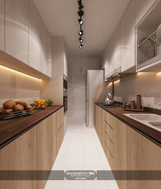 a long narrow kitchen with wooden cabinets and counter tops