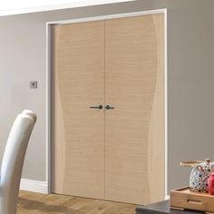 a wooden door in a room next to a table and chair