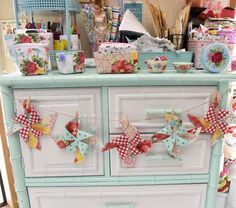 an old dresser is decorated with red, white and blue decorations