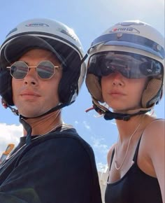 the man and woman are wearing helmets on their heads