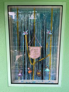 a window that has some items in it and is decorated with blue tinsels