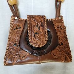 "Great bag, great condition! Never used, new! 8.5\" wide x 6.5\" high x 2\" leather hand tooled Zaria label on front Wooden beads" Hand Tooled Brown Bag, Unique Hand Tooled Brown Bag, Unique Hand-tooled Brown Bag, Vintage Brown Hand Tooled Rectangular Shoulder Bag, Vintage Brown Rectangular Hand Tooled Shoulder Bag, Hand-tooled Brown Shoulder Bag For Festivals, Hand Tooled Brown Shoulder Bag For Festivals, Bohemian Brown Hand-tooled Shoulder Bag, Vintage Brown Hand Tooled Crossbody Shoulder Bag