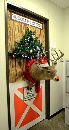 a deer head mounted to the side of a wall with a christmas tree on it