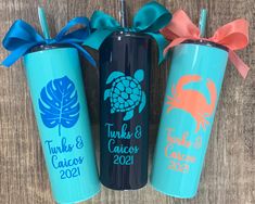 three personalized tumbles with bows on the top, one blue and one pink