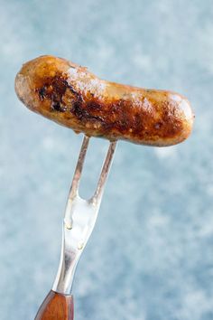 a hot dog on a fork with powdered sugar