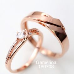 two gold wedding rings with diamonds on each one and the word gemsna in white lettering