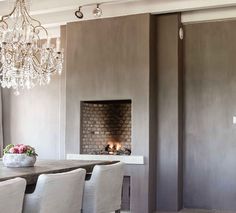 a dining room table with chairs and a chandelier