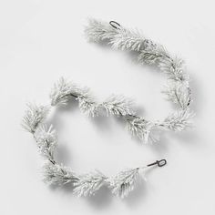 a white christmas garland with pine needles