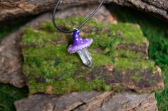 A suitable decoration for a forest witch is a fly agaric pendant. Unusual and bright. Completely handmade. Glass eye. Made of polymer clay, painted with acrylic and coated with epoxy to simulate glaze (like ceramics). Leg natural quartz Cord included.Made with love and magic.Details:Purple mushroom length 4.5cm (1.8")Pink mushroom the hat glows in ultraviolet light. Length 3.5cm (1.4")Cord length 43.5cm (17") (can be extended by another 5cm (2"))All my products are completely handmade, so there Clay Mushroom Necklace, Mushroom Resin Jewelry, Whimsical Mushroom Design Necklace For Gift, Polymer Clay Mushroom Design Jewelry Gift, Polymer Clay Mushroom Necklace, Polymer Clay Mushroom Pendant, Polymer Clay Mushroom, Pink Mushroom, Glass Eyes