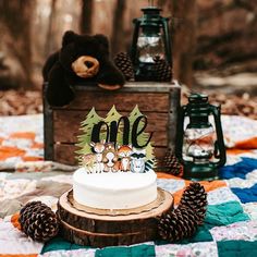 a cake sitting on top of a wooden table covered in frosting and pine cones