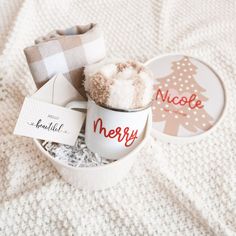 a white cup with some stuff in it on top of a bed next to a tag