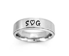 "AWESOME 6 mm Comfort Fit Band, goes on like silk and will be the most comfortable ring you'll ever wear. This is a stainless steel brushed finish on a flat surface with a shiny belveled rim. Add names, dates, quotes, coordinates, scripture or Roman Numerals. I hand stamp each letter then use the best quality black jewelry paint, clean and polish. If you want the ring with no paint in the stamping leave note. I ONLY stamp on the outside of the ring. To customize: at checkout in box \"note to Let Round Custom Name Jewelry For Promise, Custom Name Round Jewelry For Promise, Wedding Rings Stainless Steel Round Band, Wedding Stainless Steel Ring With Round Band, Wedding Stainless Steel Round Band Rings, Thick Band Engraved Promise Ring, Customizable Adjustable Rings For Promise, Modern Personalized Round Band Rings, Personalized Modern Round Band Rings